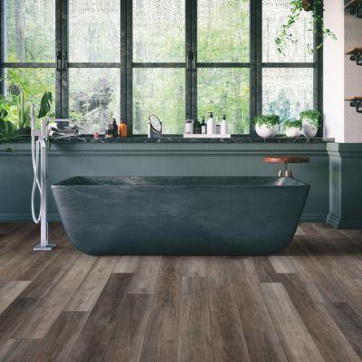 luxury vinyl plank flooring in a monochrome Seattle bathroom with green tub
